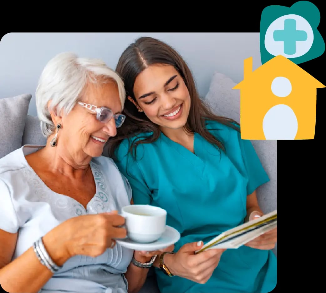 Older woman and nurse smiling on a couch