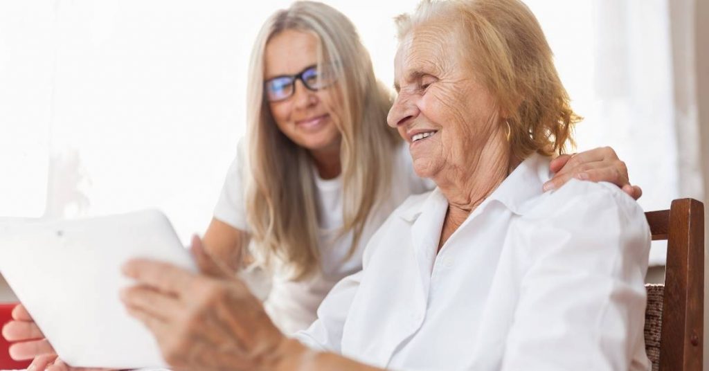elderly woman and family member using online carer marketplace to find care workers