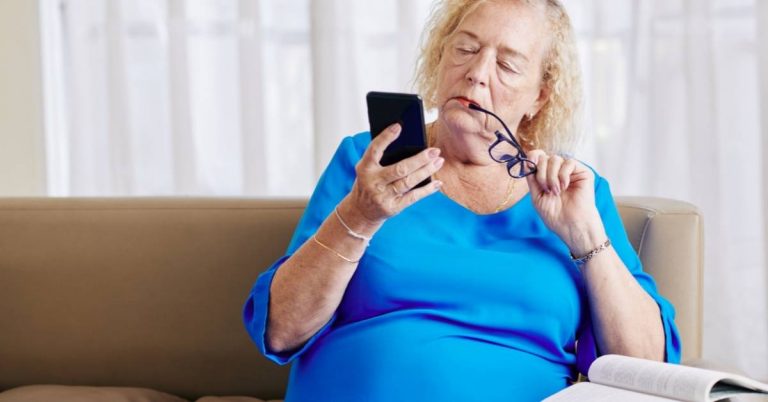 older woman questioning phone screen