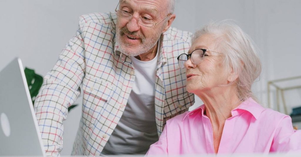elderly couple choosing a home care package provider online